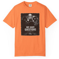 Load image into Gallery viewer, Orange t-shirt with a graphic design and text 'WE HAVE QUESTIONS' on a white background