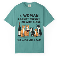 Load image into Gallery viewer, Green Comfort Colors T-shirt featuring cats beside a wine bottle and glass with A Woman Cannot Survive on Wine Alone She Also Needs Cats text.