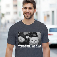Load image into Gallery viewer, Man wearing a t-shirt with a cat graphic and text on a city street.
